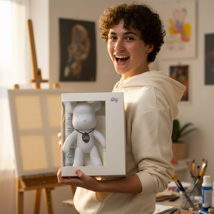 Boy proudly holding a DubaiDripArtβ’ fluid art gift box with a bear kit
