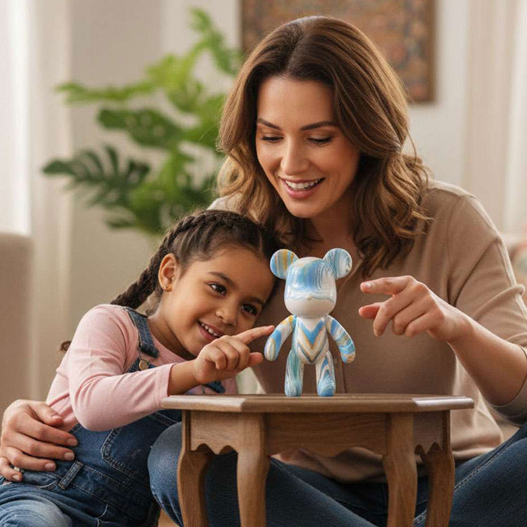 mother and child smiling at their DIY flow-paint figurine standing on the table