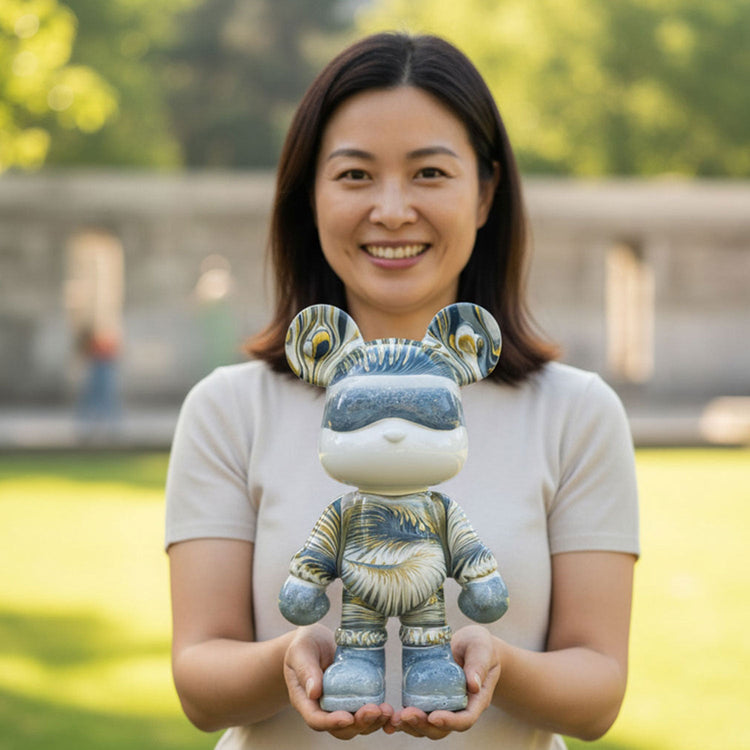 woman proudly holding a 33 cm Dubai Drip Art bear figurine painted in swirling marble colors