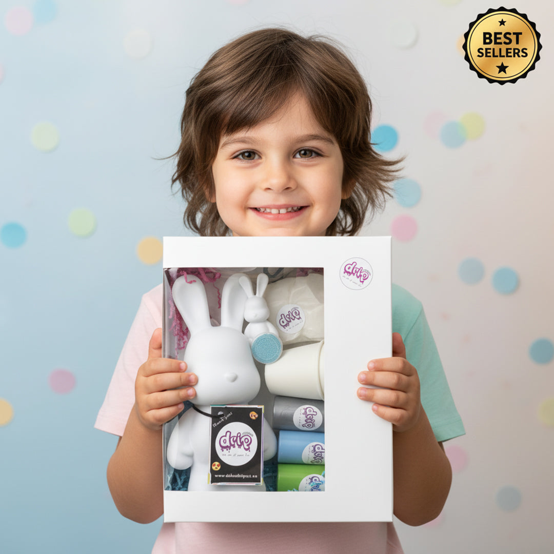 Child smiling while showing a Dubai Drip Art bear gift box